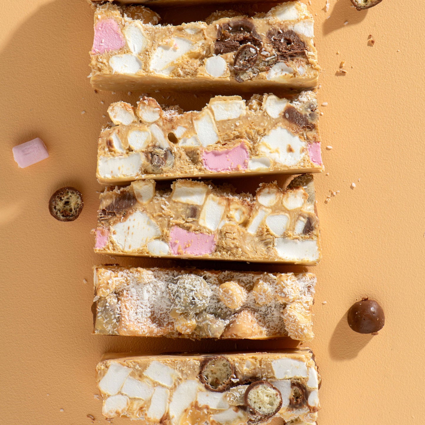 Five sliced bars of a dessert on a beige background
