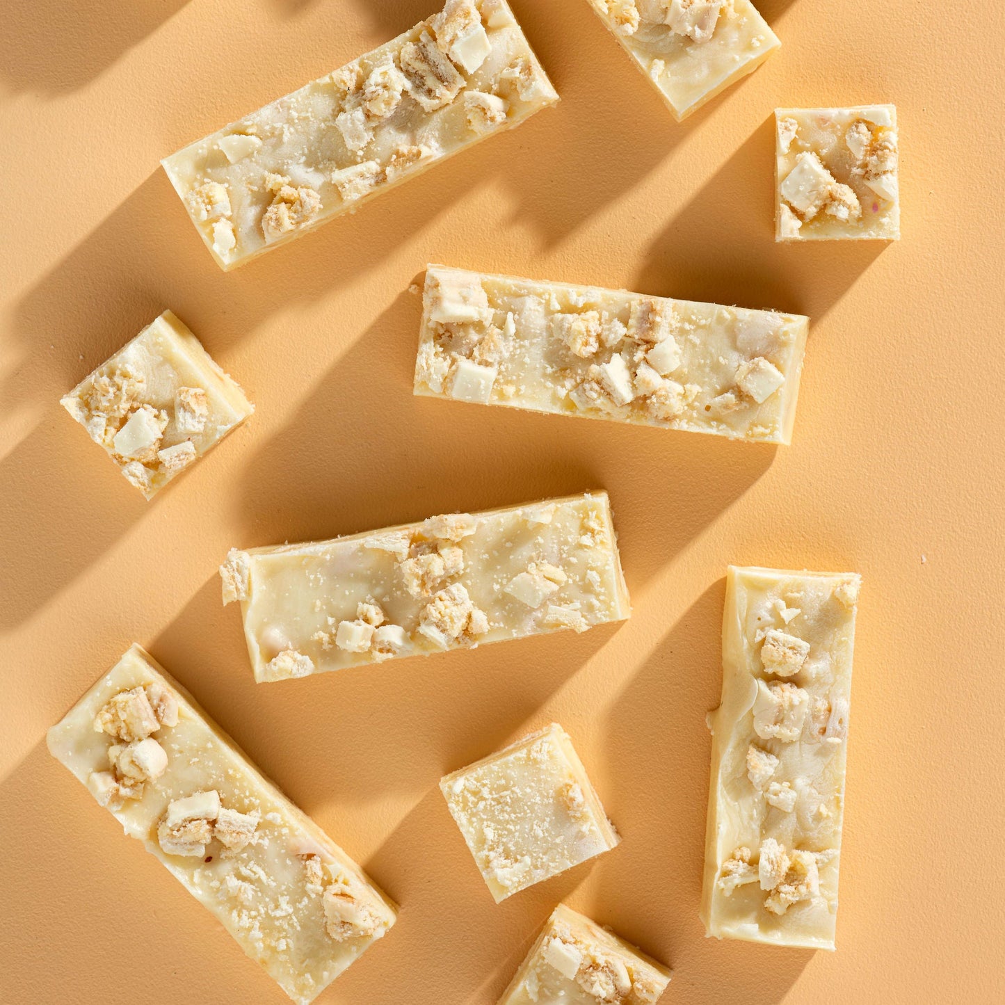 Bars of soap with popcorn pieces on a beige background