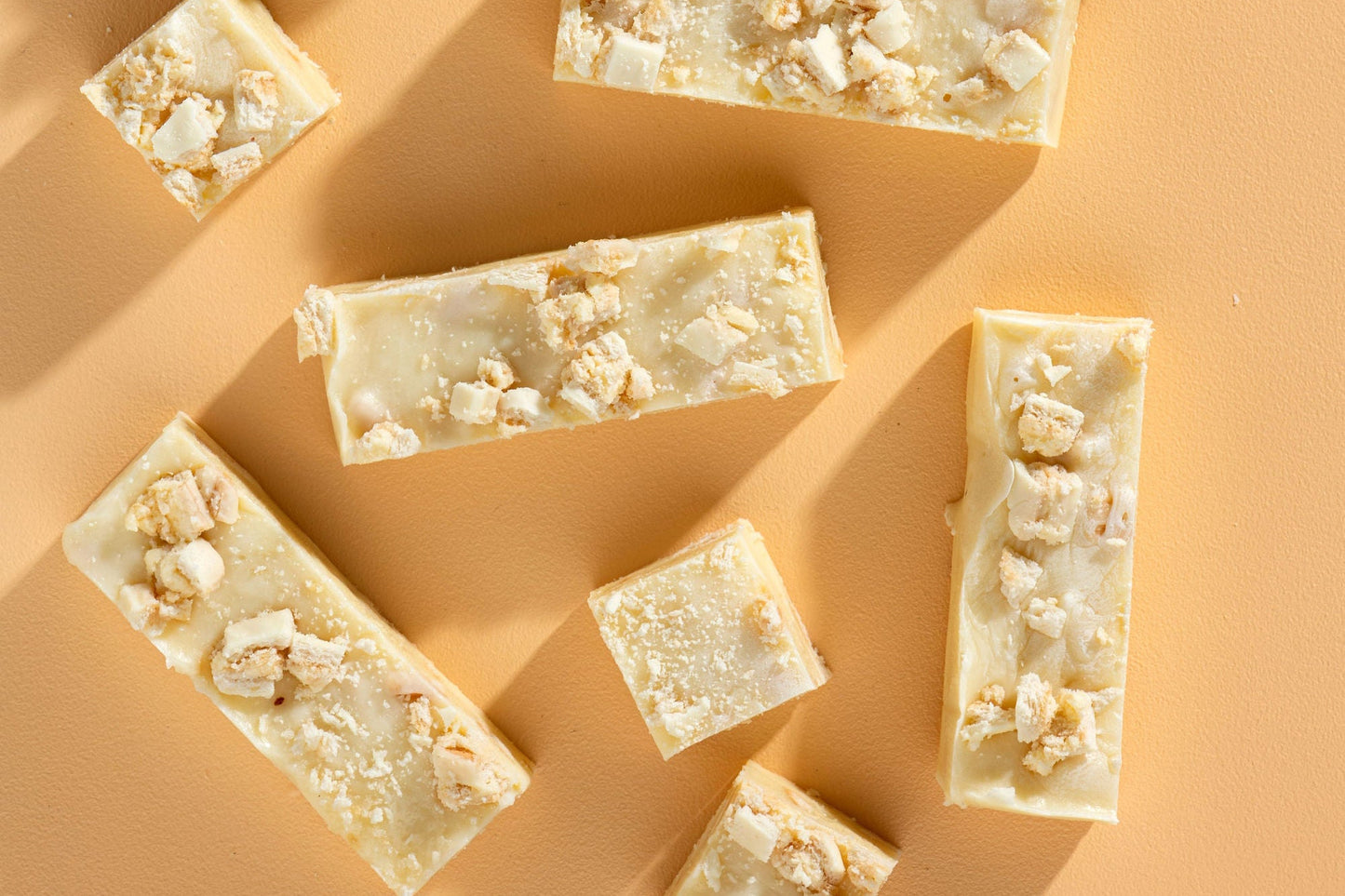 Bars of soap with popcorn pieces on a beige background