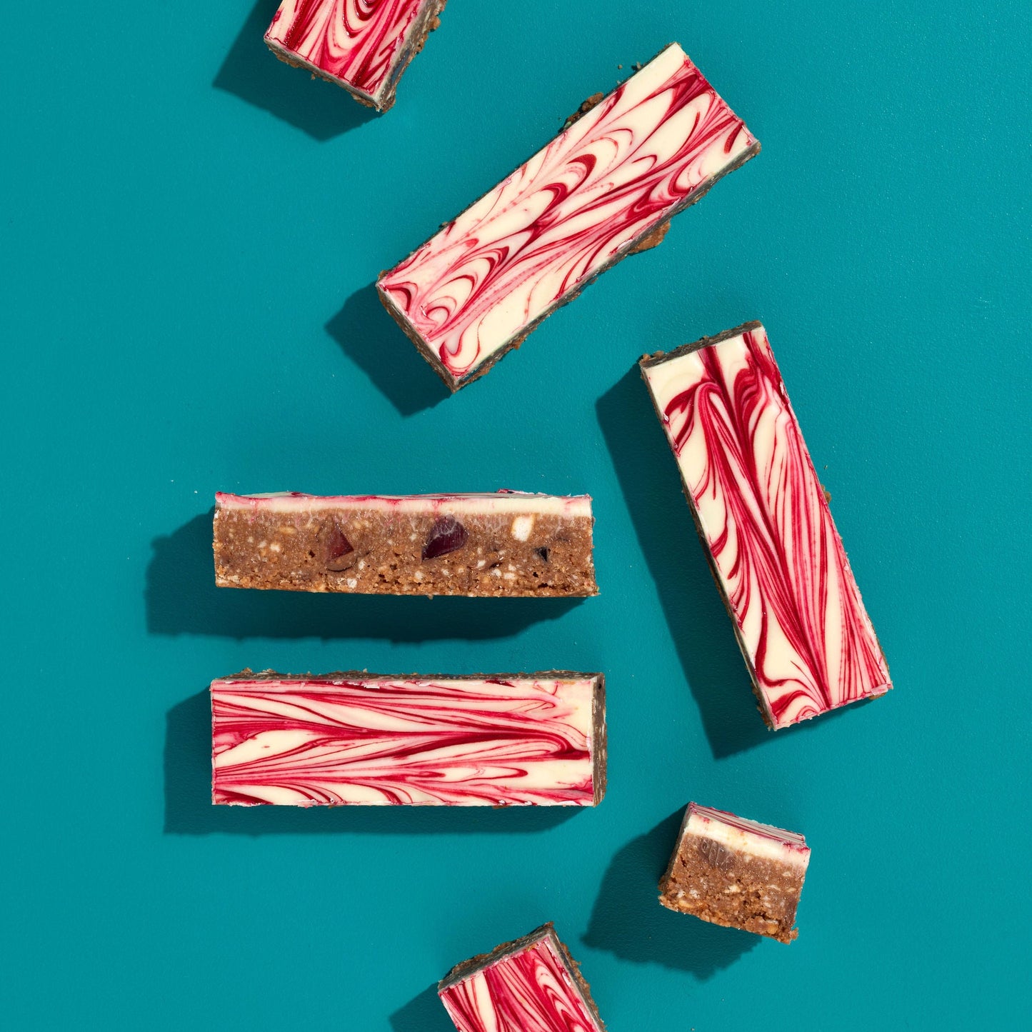 Marbled chocolate bars on a teal background