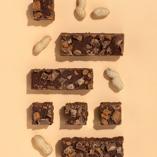 Chocolate bars with nuts on a beige background