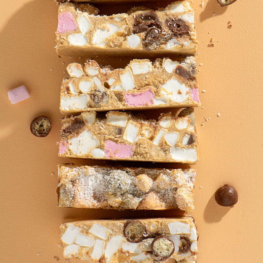 Five sliced bars of a dessert on a beige background