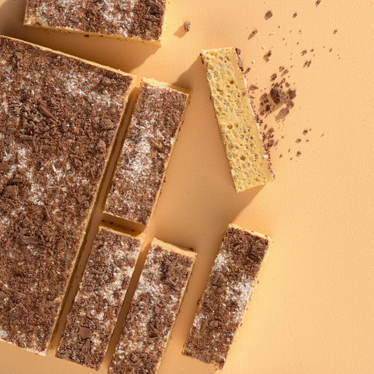 Chocolate bars with a knife on a beige background