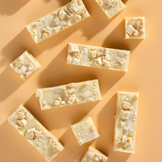 Bars of soap with popcorn pieces on a beige background