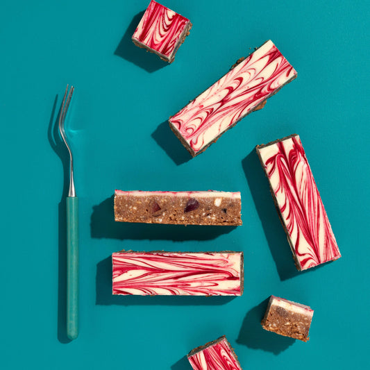 Marbled chocolate bars on a teal background with a fork